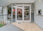 Thumbnail 9 of 27 - A glass door with a red sign on it.