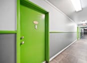 Thumbnail 6 of 27 - A green door with a number 130 on it.