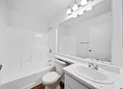 Thumbnail 27 of 27 - A white bathroom with a toilet, sink, and bathtub.