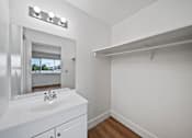Thumbnail 13 of 17 - A white bathroom with a sink and mirror.