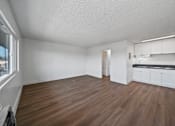 Thumbnail 16 of 17 - A room with wooden flooring and white walls.