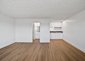Thumbnail 15 of 17 - A room with wooden floors and white walls.