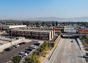 Thumbnail 4 of 17 - A parking lot with a mountain in the background.