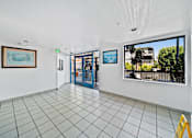 Thumbnail 12 of 12 - A room with a tiled floor and a painting on the wall.