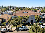 Thumbnail 2 of 12 - A white truck is parked in front of a house.
