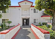 Thumbnail 5 of 12 - A white building with a red roof and a black awning with the number 5708 on it.