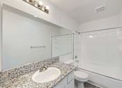 Thumbnail 15 of 15 - A bathroom with a sink, toilet, and shower.