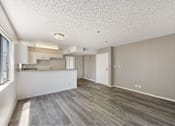 Thumbnail 5 of 15 - A kitchen area with a counter and cabinets.