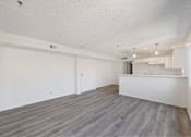Thumbnail 7 of 15 - A spacious room with a grey floor and white walls.