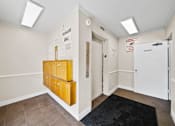Thumbnail 8 of 10 - A hallway with a black rug and a yellow filing cabinet.