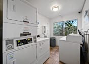 Thumbnail 4 of 18 - A room with a washing machine and a dryer.