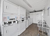 Thumbnail 8 of 10 - A laundry room with washers and dryers.