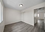 Thumbnail 34 of 38 - A room with a wooden floor and white walls.