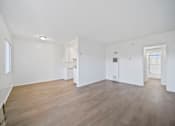 Thumbnail 20 of 20 - A large empty room with wooden floors and white walls.