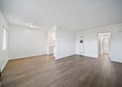 Thumbnail 15 of 20 - A room with wooden floors and white walls.