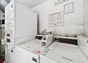 Thumbnail 13 of 20 - A white washing machine with a control panel on top.