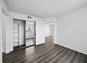 Thumbnail 25 of 33 - A room with a white wall and a wooden floor.