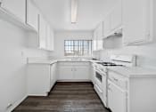 Thumbnail 20 of 33 - A white kitchen with a window.