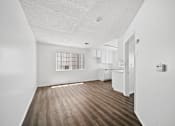Thumbnail 16 of 33 - A room with wooden floors and white walls.