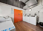 Thumbnail 16 of 29 - A room with a white printer and orange door.