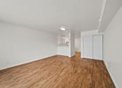 Thumbnail 17 of 29 - A room with wooden floors and white walls.
