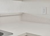 Thumbnail 20 of 29 - A white electrical outlet is mounted on a white wall.