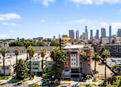 Thumbnail 4 of 29 - A cityscape with a clear blue sky and buildings in the distance.