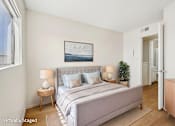 Thumbnail 2 of 21 - A bedroom with a large bed and a painting on the wall.