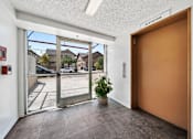 Thumbnail 6 of 21 - A brown door with a sign above it that says "elevator".