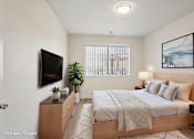 Thumbnail 1 of 17 - A large bedroom with a window letting in natural light