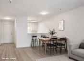 Thumbnail 2 of 17 - A dining room with a table and chairs.