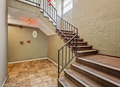 Thumbnail 8 of 17 - A staircase with a metal railing and wooden steps.