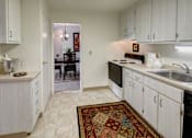 Thumbnail 10 of 11 - Classic kitchen with large pantry,  electric stove, dishwasher, and fridge at Kings Gate West Apartments, Camillus