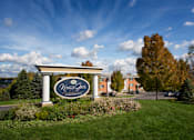Thumbnail 1 of 11 - A Kings Gate Apartments sign is in front of a building and trees at Kings Gate West Apartments, Camillus 13031