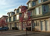 Thumbnail 1 of 13 - A row of houses with trees in front of them. at Seaview Apartments in Staten Island, NY, 10305