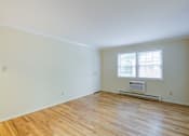 Thumbnail 9 of 22 - A room with a window and a radiator on the wall at Rivercrest Apartments, Piscataway
