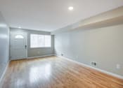 Thumbnail 13 of 13 - A room with a wooden floor and a white door at Seaview Apartments in Staten Island, NY, 10305