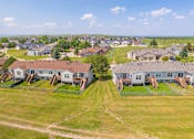 Thumbnail 15 of 21 - A bird's eye view of the residential area with houses and green lawns at Antelope Ridge.
