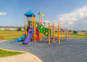 Thumbnail 18 of 21 - A playground with a purple slide and a yellow and green structure.