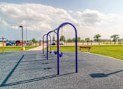Thumbnail 17 of 21 - A blue swing set and parking lot.