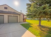 Thumbnail 14 of 21 - A house with a garage and a tree in front at Antelope Ridge.