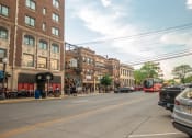 Thumbnail 7 of 20 - a city street with cars and buses and buildings  at Antelope Ridge, Box Elder, South Dakota