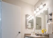 Thumbnail 37 of 48 - A white toilet sits next to a sink in a small bathroom.