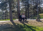 Thumbnail 3 of 20 - two people sitting on a bench in a park  at Antelope Ridge, Box Elder, 57719