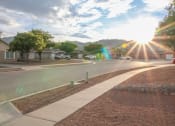 Thumbnail 22 of 31 - a street with houses and trees and the sunset  at Village of Cottonwood Springs in El Paso, TX