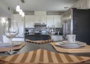 Thumbnail 25 of 31 - kitchen with white cabinets and stainless steel appliances at Village of Cottonwood Springs, El Paso TX