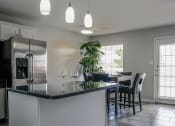 Thumbnail 27 of 31 - kitchen with a large island and a dining room in the background