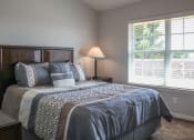 Thumbnail 28 of 31 - a bedroom with a large bed and oversized window at Village at Cottonwood Springs in El Paso