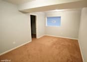 Thumbnail 5 of 14 - a empty room with a blue and white wall and a carpet