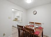 Thumbnail 10 of 37 - A dining room with a table set for four.